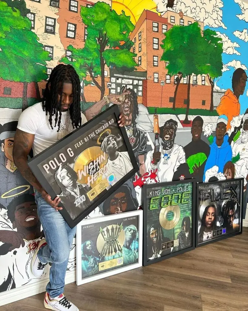 Polo G Holding his RIAA certified music awards